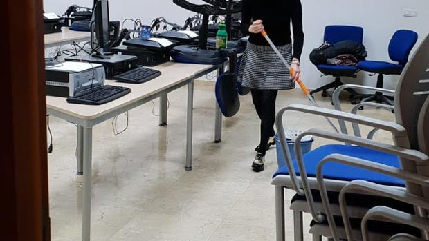 Una alumna limpiando el aula con productos traídos de casa.